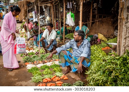 CHENNAI, INDIA - JANUARY 09, 2014: A young Indian man at his fruit and vegetable shop in a small rural village south of Chennai.