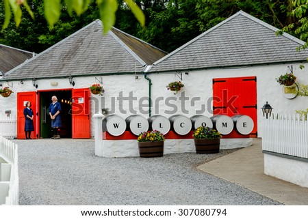 PITLOCHRY, SCOTLAND - JUNE 23: Welcome sign and tour guides at the Edradour Distillery, near Pitlochry Scotland\'s smallest distillery.