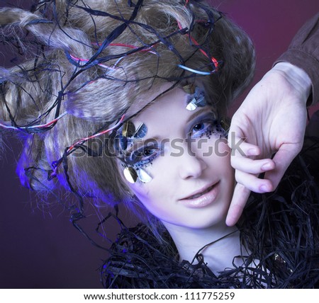 Dark fairy. Portrait of young woman with creative visage and hairstyle.