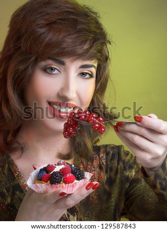 Young woman with cake with fresh berries