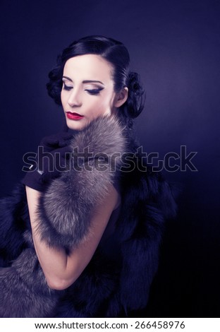 Vintage lady. Young woman in brown dress and in furs.