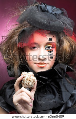 Young stylish lady in vintage hat with cakes