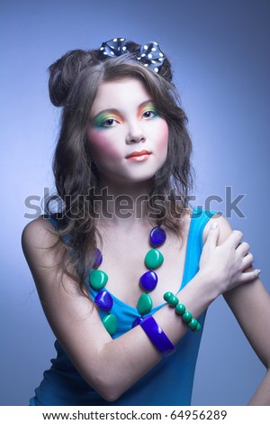 Young charming woman with bright visage and with long dark hair and bow.