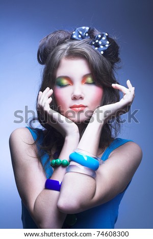 Young charming woman with bright visage and with long dark hair and bow.