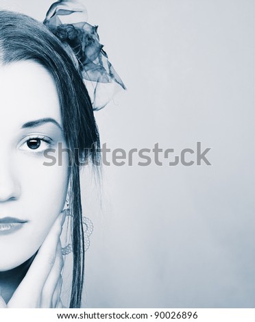 Half face of  young woman with bright visage.