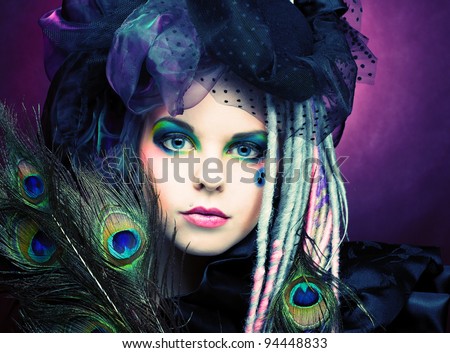 Young lady witn creative make-up in vintage hat