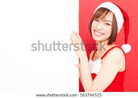 young Christmas woman with santa hat showing blank billboard against red background