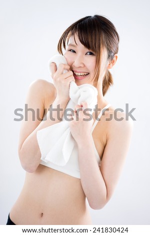 fitness woman wiping the sweat off with towel