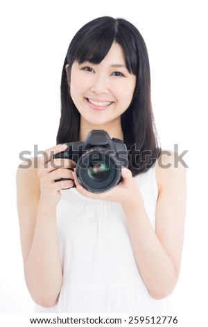 happy young woman taking photo with digital single-lens reflex camera, isolated on white background