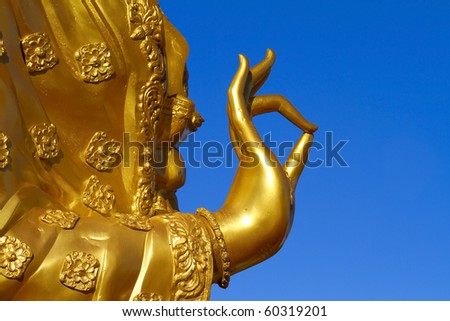 Buddha statues hand. Against a backdrop of sky