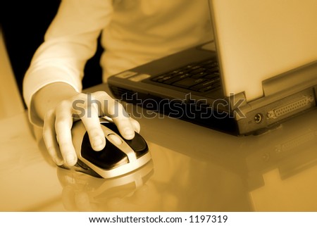 a girl using a laptop computer on a highly polished glass desk
