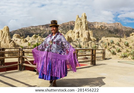 LA PAZ, BOLIVIA - MARCH 31, 2013: An unidentified woman in traditional colourful clothes in Valle de la Luna - touristic attraction in La Paz, Bolivia.