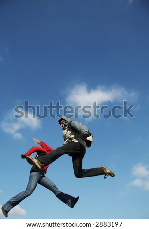 Two jumping person on the blue background