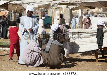 DARAW, EGYPT - DECEMBER 29: Arab people are bargaining at weekly camel and livestock market on December 29, 2009 at Daraw town near the Aswan.