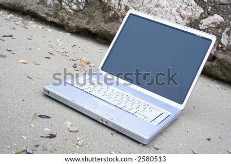 laptop notebook on the sea-sand
