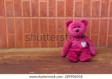 Pink Bear toy alone on wooden backgrounds,valentine day