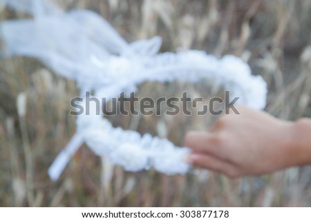 Blurred diadem of flowers on hand  ,use as background