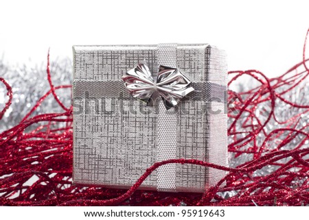 Silver gift in christmas decorations with white background