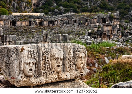 View of stone stage masks in front of an ancient amphitheater in Myra Turkey