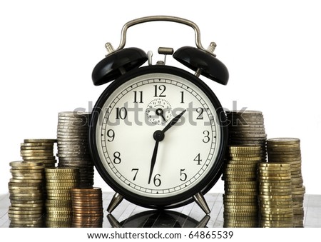 Alarm clock standing with coins on metal plate