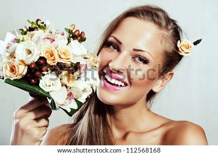 smiling young beautiful woman with flowers , glamour makeup , make-up , perfect clean skin , long hair