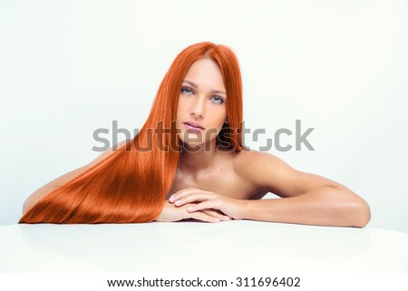 beautiful fashion model with long red hair.