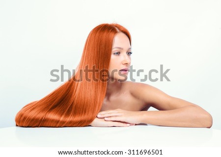 closeup portrait of a beautiful young woman with elegant long red shiny hair , hairstyle , isolated on white background , healthy straight hair