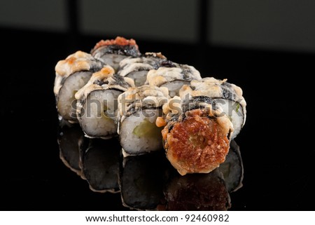 closeup of a  sushi roll , japanese food , on black background