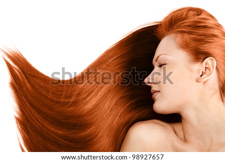 portrait of a beautiful young woman with healthy long red hair