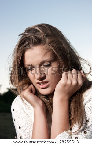 Angry woman with hands in her hair pulling