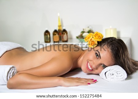 Relaxed young woman getting a massage in a beauty salon
