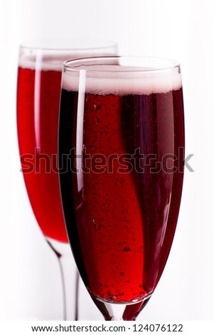 pink champagne in a flute served over a white background