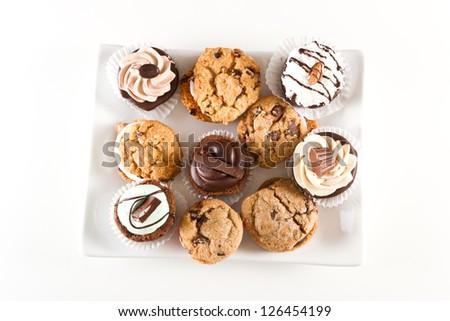 plate full of an assortment of cookies and mini brownie bites