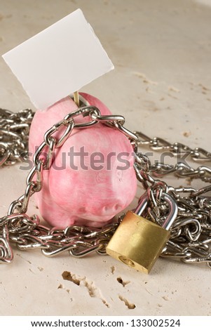 concept of a bad economy  piggy bank with lock and chain