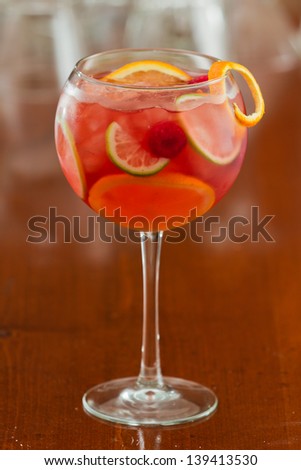 red sangria served in a wine glass with fresh organic fruit
