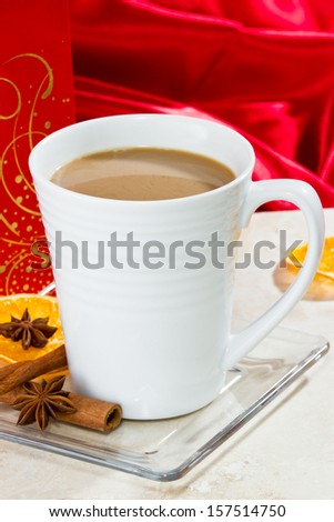christmas morning coffee served on a marble table with cinnamon and star anise on the side