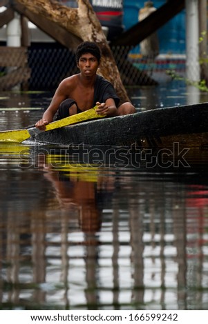 New river, Belize- November 08: Unknown mennonite fisherman in his canoe rowing to his fishing spot on the New River, November 08 2013 in Belize
