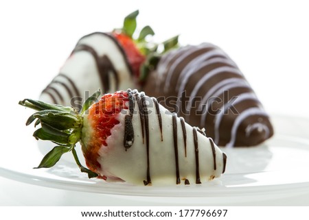 chocolate covered strawberries close up with white and dark chocolate isolated on a white background