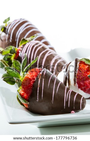 chocolate covered strawberries close up with white and dark chocolate isolated on a white background