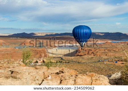 hot air balloon floating over the Glen Canyon Dam in Arizona with a beautiful landscape