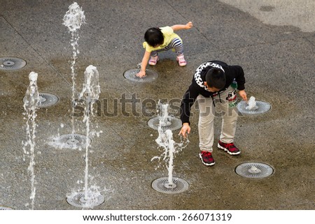 Hollywood & Highland Center, Hollywood, California - February 08 : Child playing in the water fountains, February 08 2015 in the Hollywood & Highland Center, Hollywood, California.