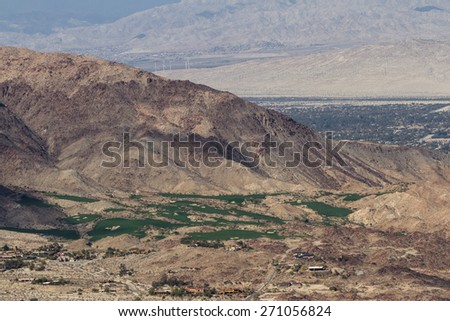 view of the desert valley from the top of a mountain in southern California, green Golf Courses in the desert.