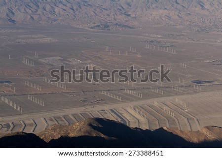 View of the Coachella Valley in California with a thick and dense smog layer and windmill farms in the valley floor and lower hills