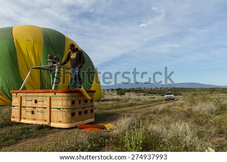 Sedona, Arizona - April 12 : Crew members guiding a deflating balloon after a successful flight, April 12 2015 in Sedona, Arizona.