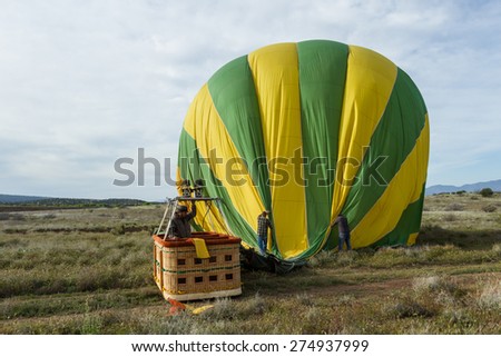 Sedona, Arizona - April 12 : Crew members guiding a deflating balloon after a successful flight, April 12 2015 in Sedona, Arizona.
