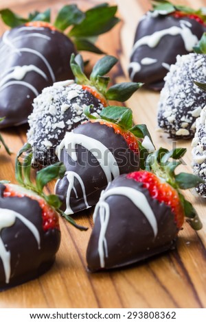 Hand dipped strawberries in chocolates with some rolled in roasted cashews and some with a white chocolate drizzle