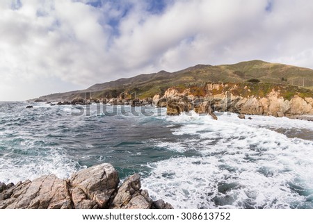 beautiful scene of the California coast on a cloudy day with its classic dramatic coastline lined with rocks and cliffs