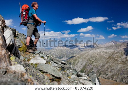 Young man with backpack on a mountain hike