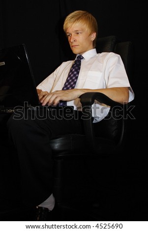 Business man with laptop on black background