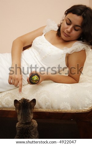 Bride teaching cat to sit